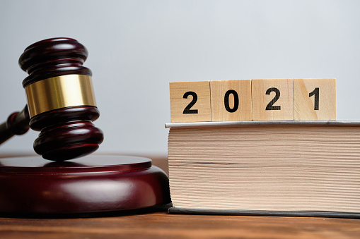 The concept of new laws in 2021 next to the judge hammer.